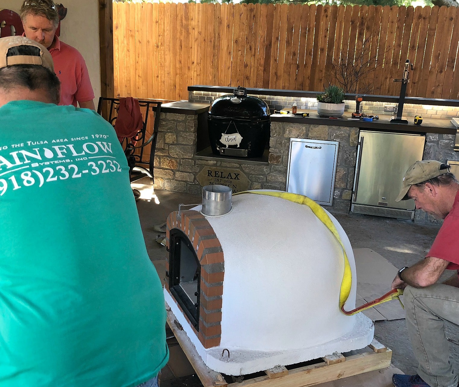 unloading pizza oven in outdoor kitchen area