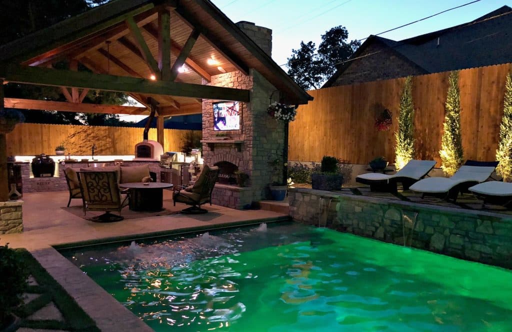 Completed backyard craftsmen living space with pool