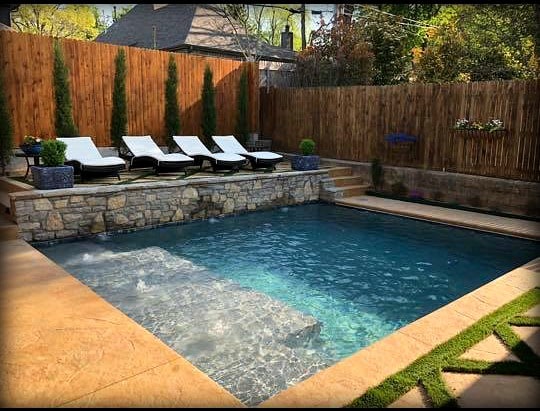 Pool finished with water, lounge ledge with lounge chairs