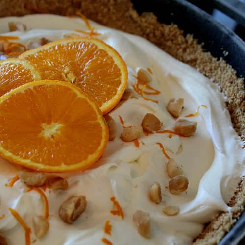 Orange Cream Dreamy Cast Iron Icebox Pie with orange zest macadamia nuts in a graham cracker crust