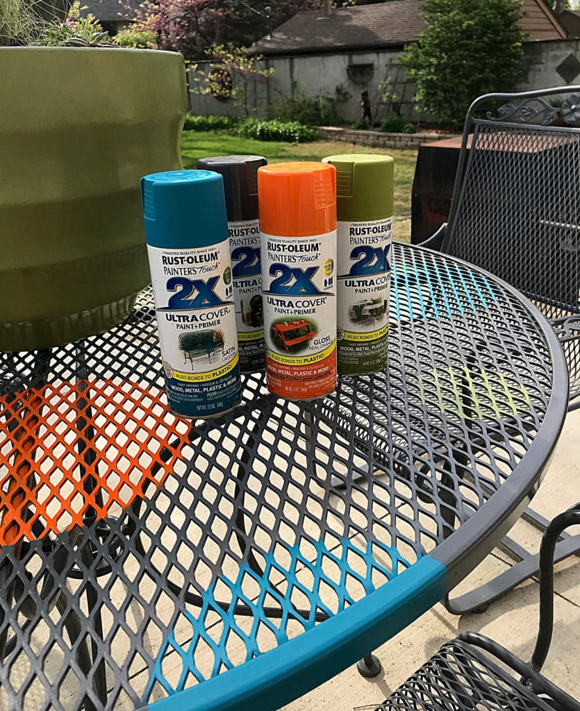 Rust-oleum Paint cans on the finished wrought iron redone with polkadots table