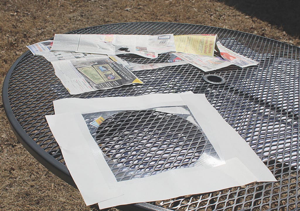 masked off Circle Stencil on table getting ready to spray orange, green, or blue