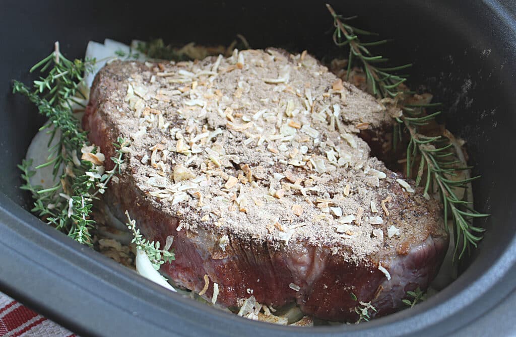 Chuck roast with Lipton's onion soup mix surrounded by rosemary and thyme.