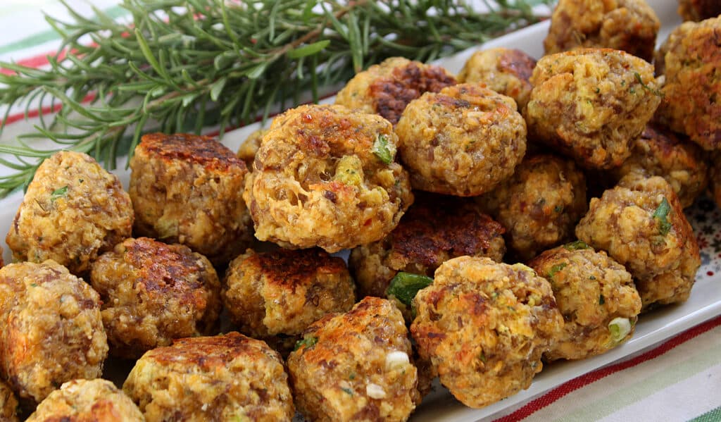 cooked sausage ball on a holiday tray with rosemary