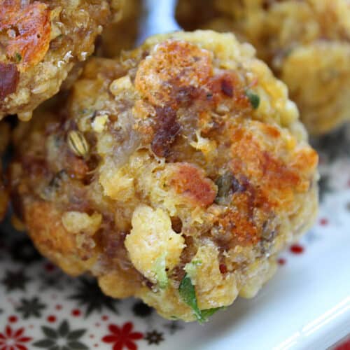 Up close sausage ball made with cornbread dressing on a holiday plate