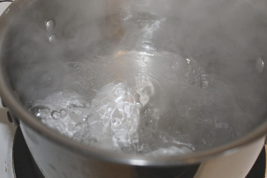 boiling eggs in a pot on the stove