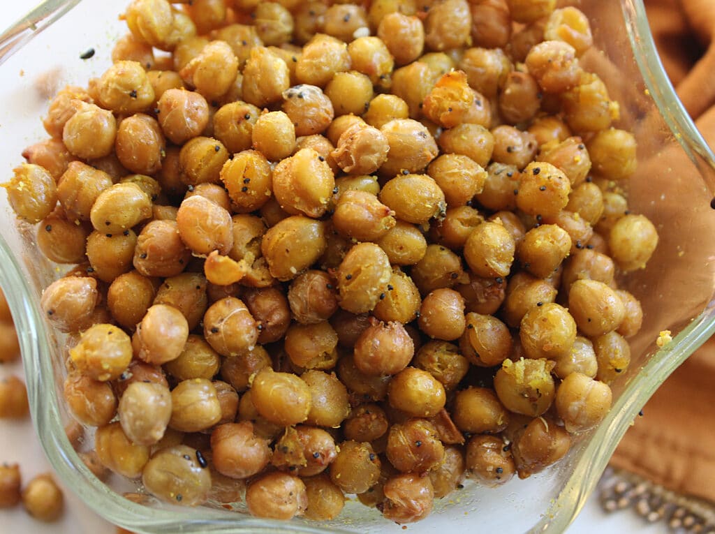 overhead close up of curry crunchy chickpeas in a glass bowl