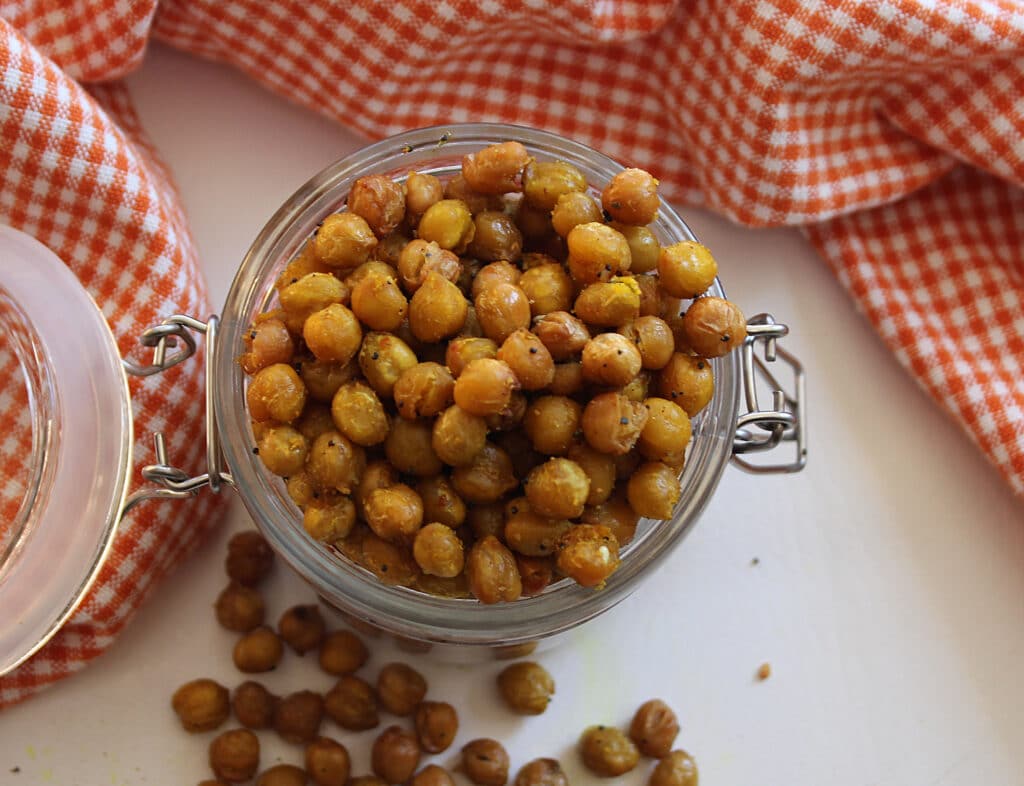 overhead shot of done curry crunchy chickpeas in a glass jar