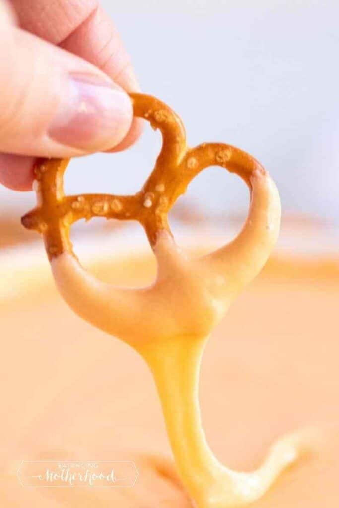 beer cheese dip in a pretzel