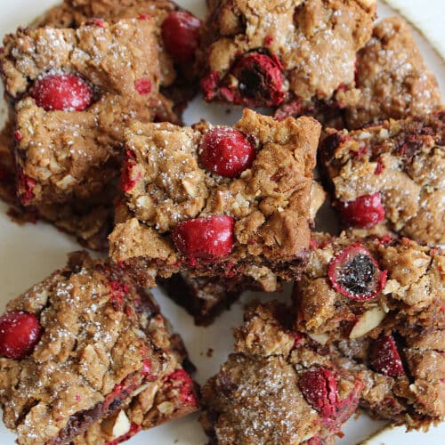 overhead of chocolate cherry chunk cookie bars on a white plate