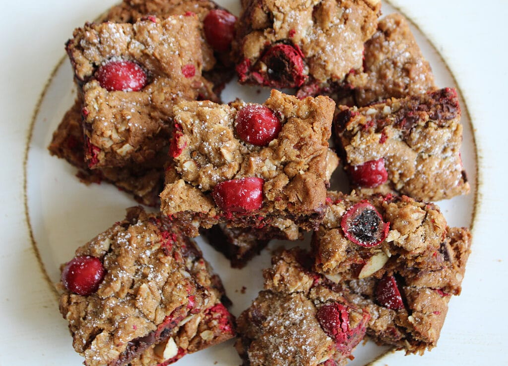 overhead picture of chocolate chunk chocolate covered cherries with oatmeal, almonds cut into squares.