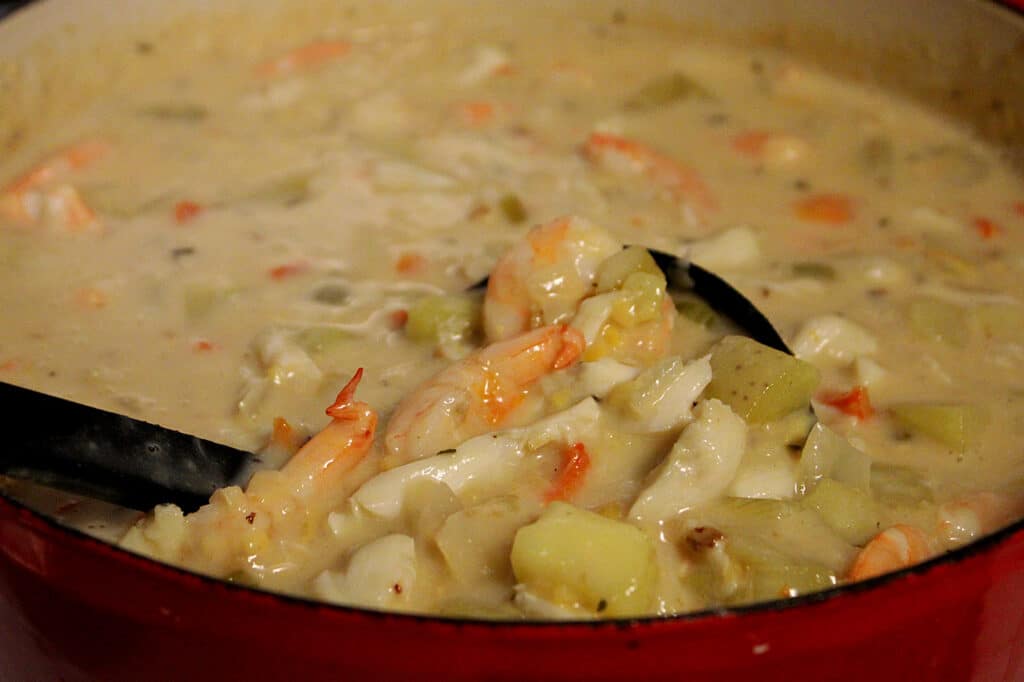 seafood chowder in a red ceramic dutch oven