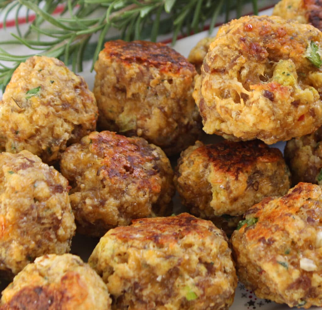 Sausage balls made with Bisquick on a holiday plate with fresh rosemary