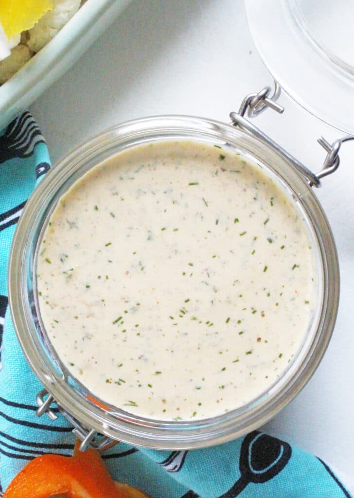 close up of jalapeno chipotle ranch dip in a glass jar.