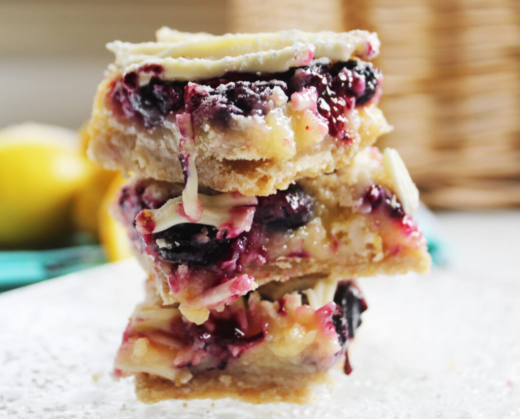 close up stack of white chocolate blueberry lemon bars