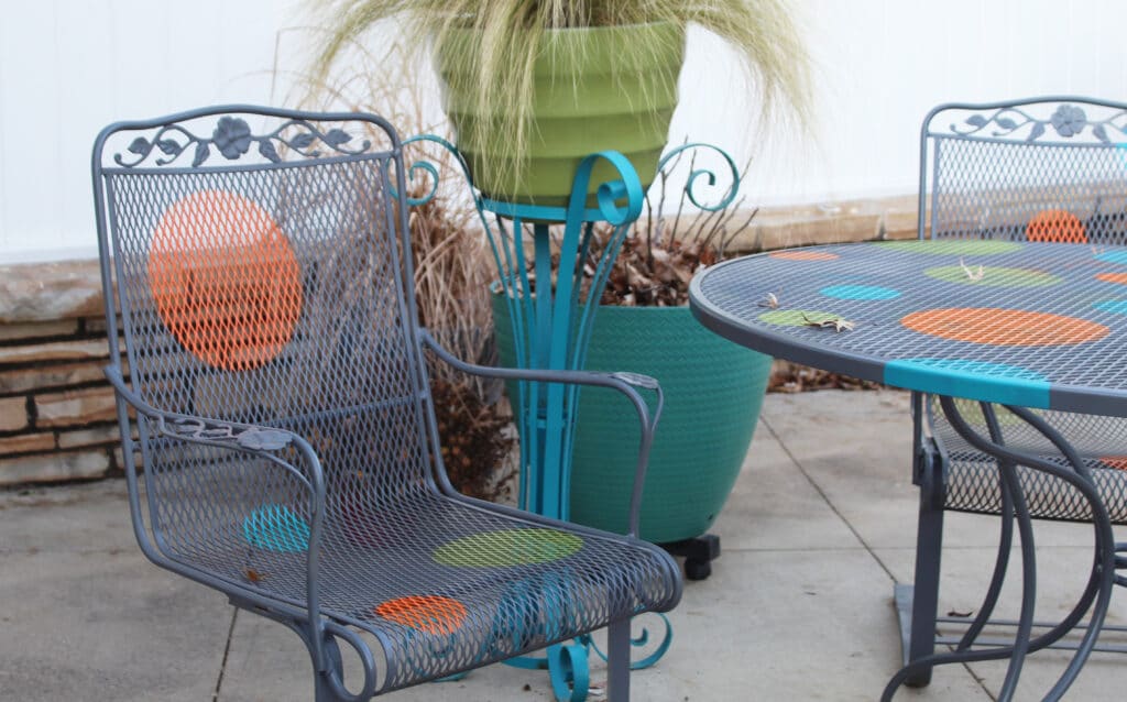 re-finished DIY wrought iron chairs with orange, blue, and green polka dots