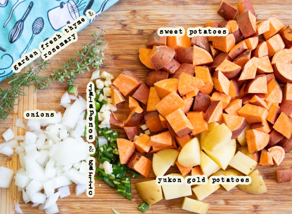 Sweet potato hash ingredients on a butcher block board.