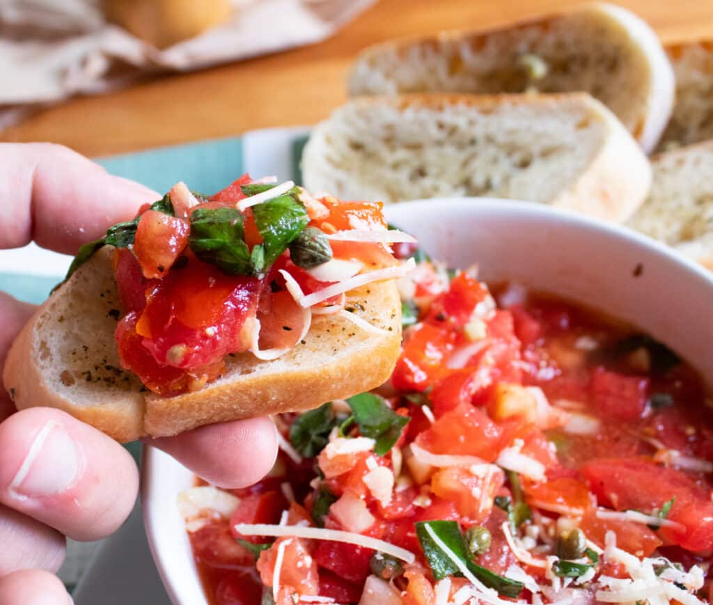 close up of bruschetta on toast over a bowl