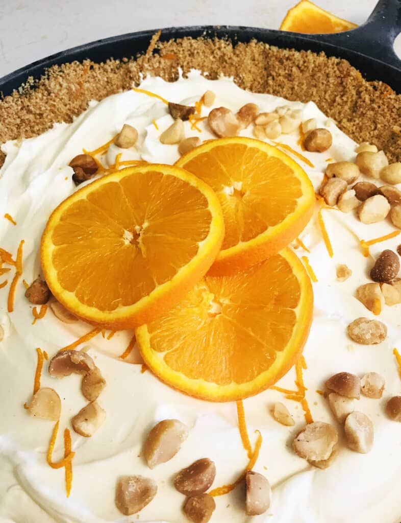 no bake orange cream chilled cast iron pie with graham cracker crust and macadamia nuts