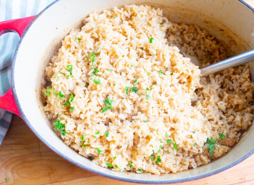 overhead baked rice in a red ceramic oven proof pot