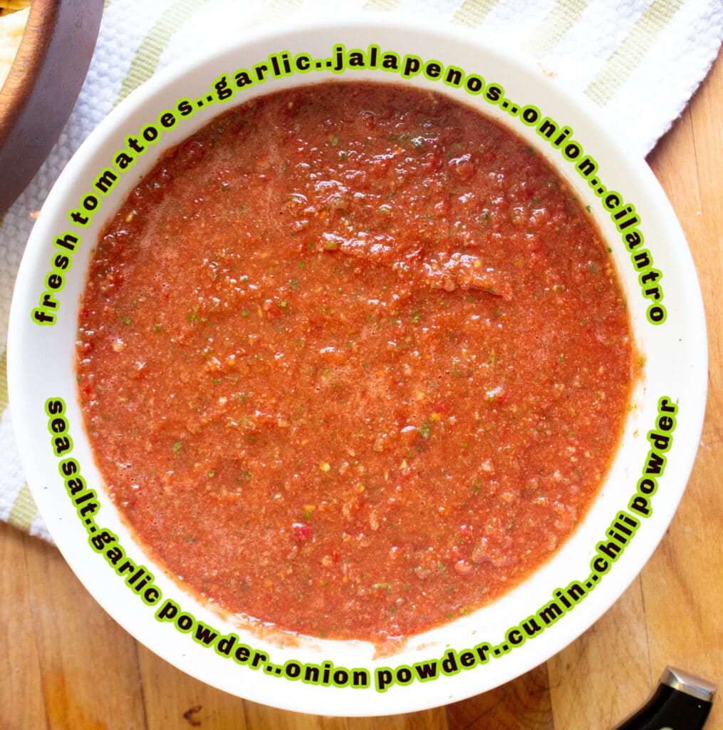 Overhead picture of homemade salsa in a white bowl on a cutting board and dish towel.