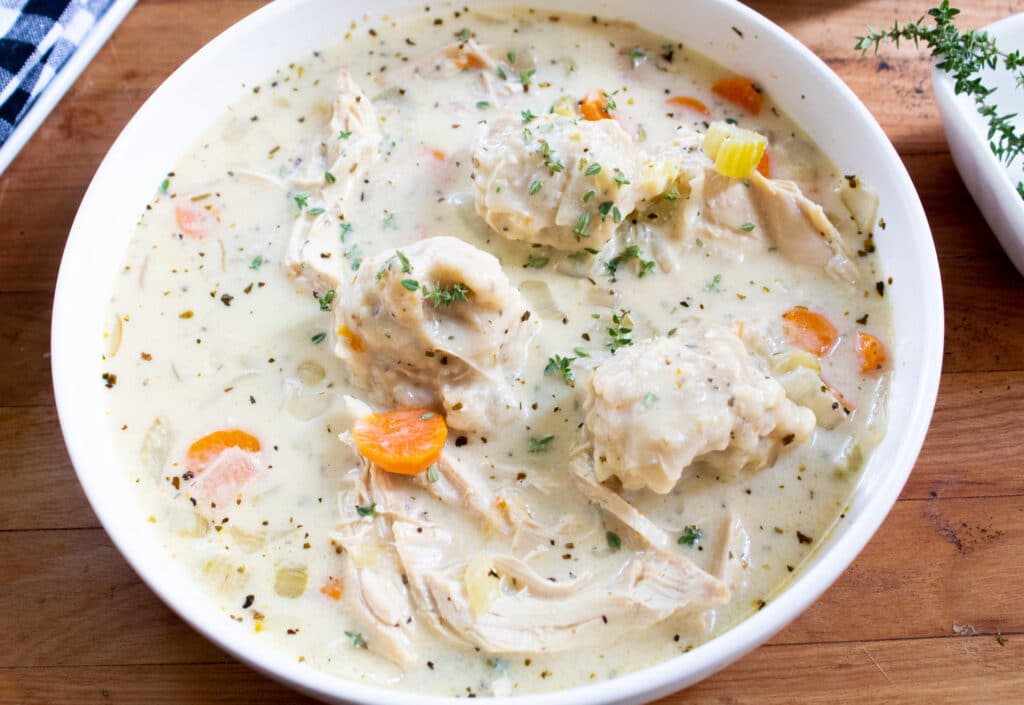 chicken and dumplings in a white bowl