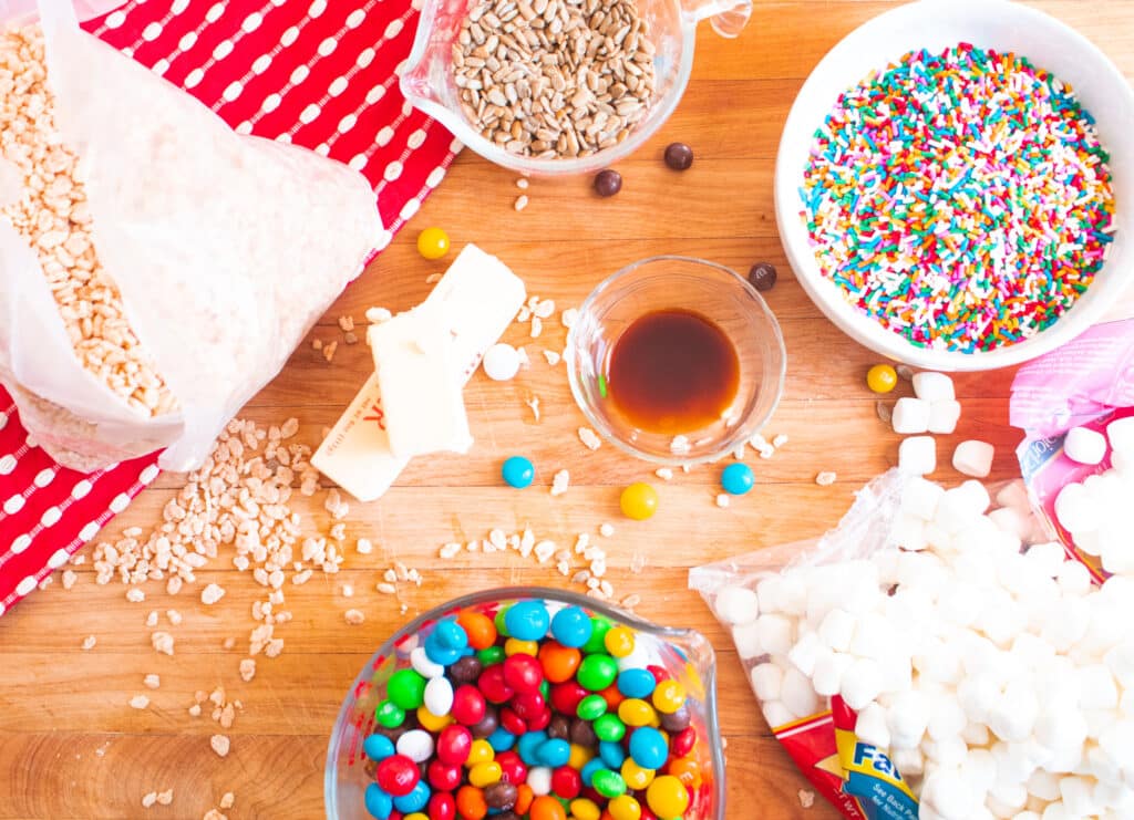 above picture of rice krispie treat ingredients on a butcher block with a red and white towel