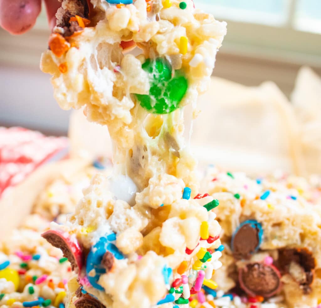 up close of a pull apart gooey rice krispie treat with M&Ms.