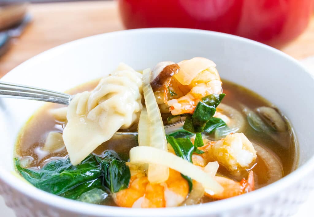 Easy 30-minute wonton soup with shrimp and spinach in a individual bowl.