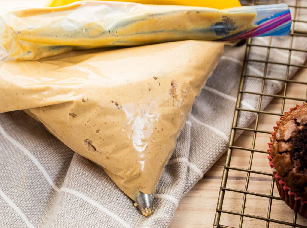 Peanut butter frosting in a plastic baggie with a frosting tip.