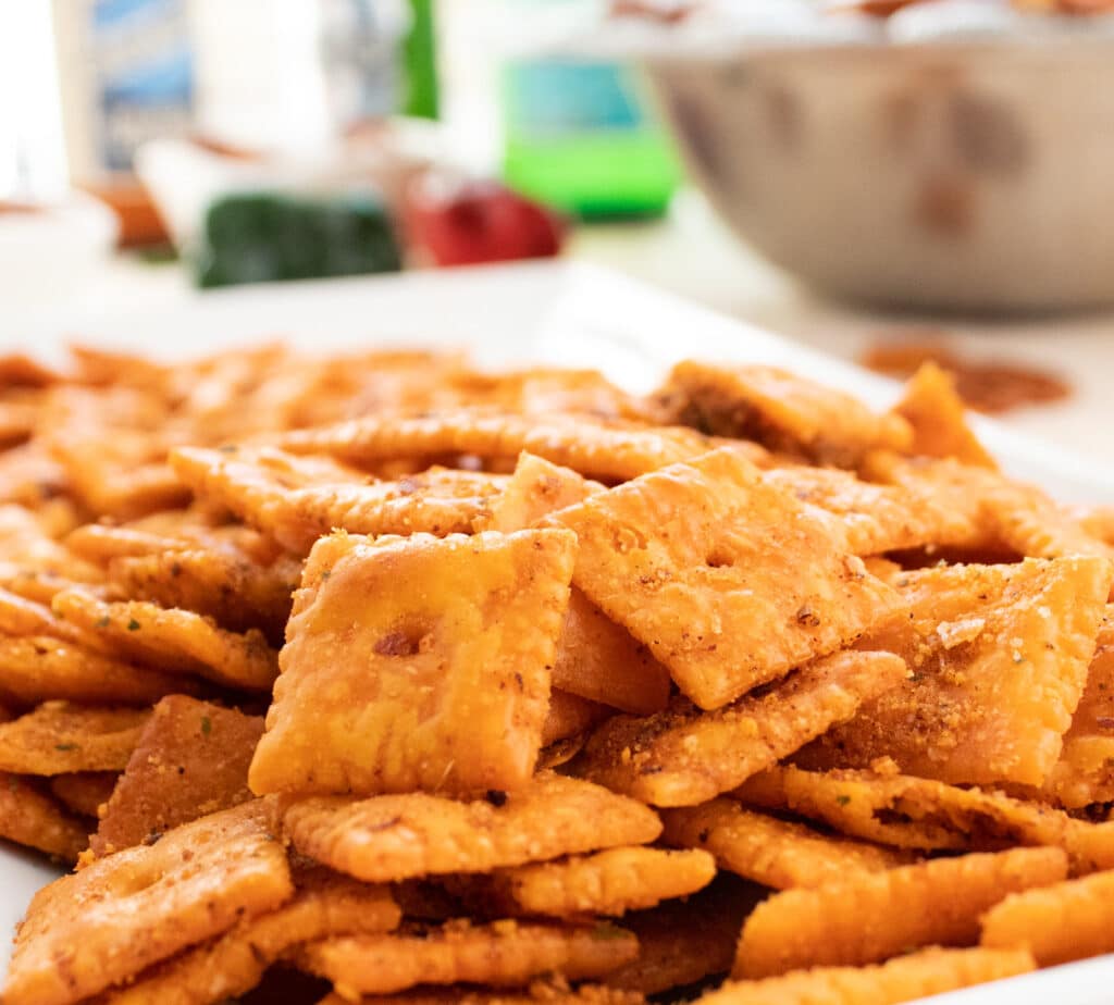 close up of feisty cheddar snack crackers on a white plate