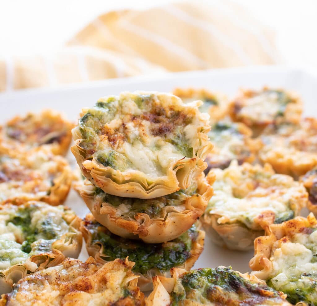 Mini spinach souffle bites in a stack.