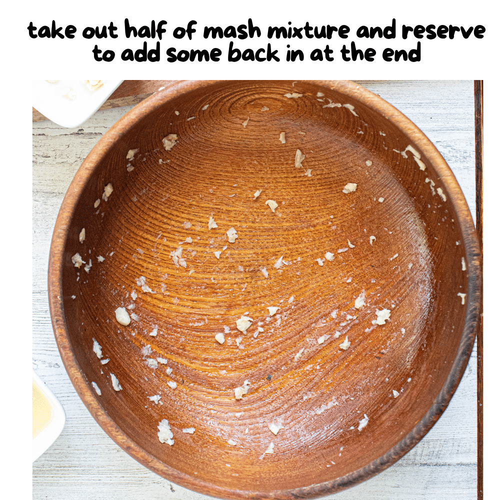 rubbed smashed garlic-salt mixture with half taken out in a wooden bowl.