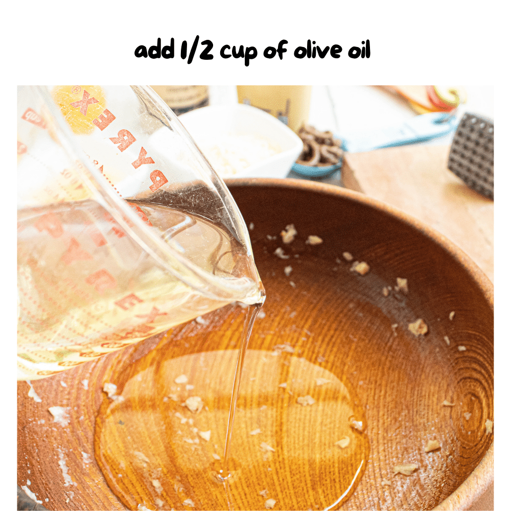 step 3 - olive oil added to wooden bowl and swirled around all inside.