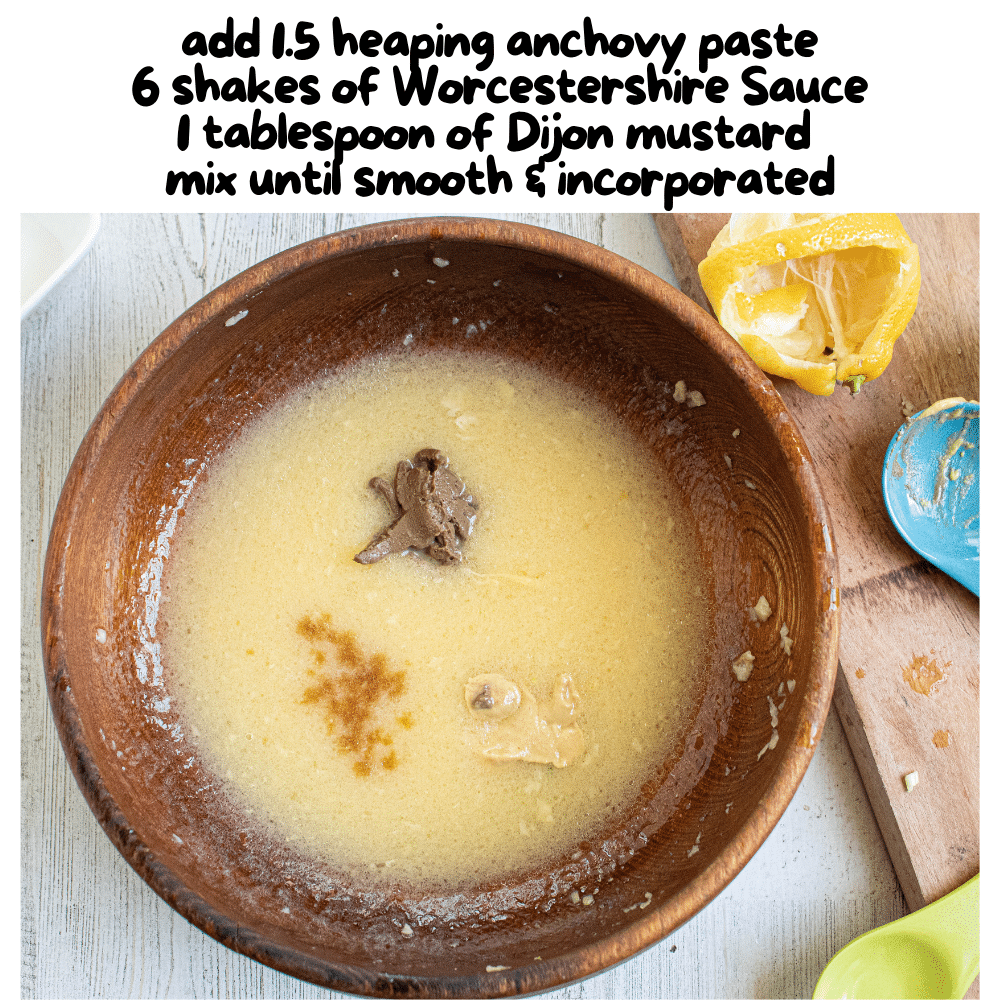 anchovy paste, Worcestershire sauce, Dijon mustard add in and  mixed with kitchen spoon in wooden bowl.