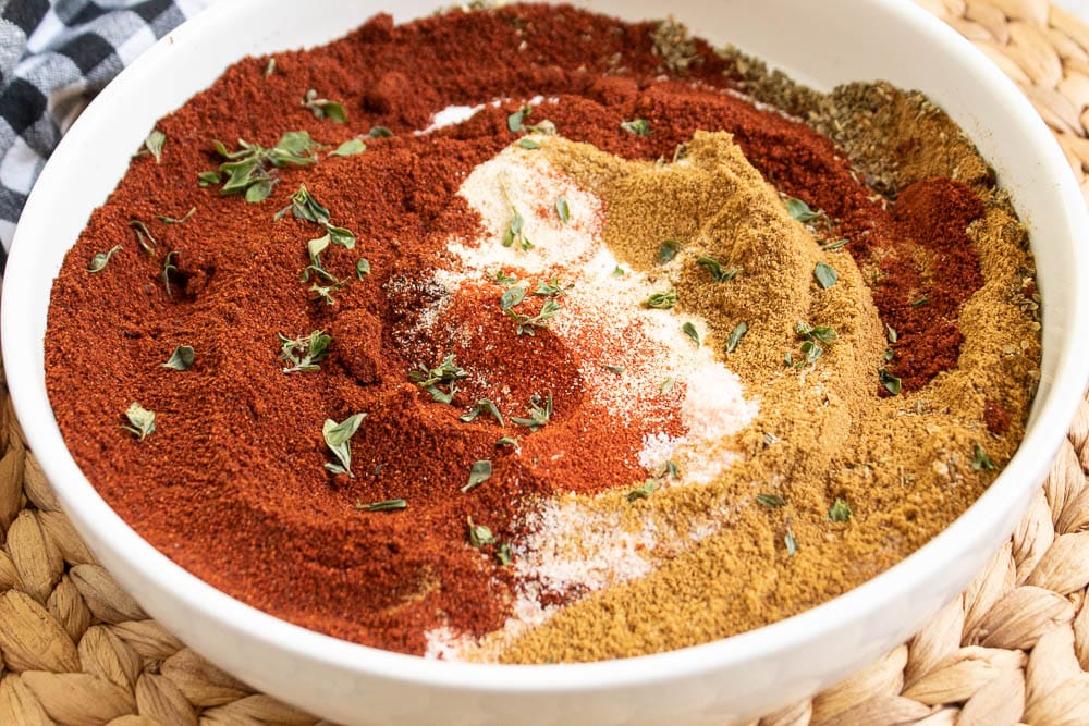 stirred mexican spice blend ingredients in a white bowl