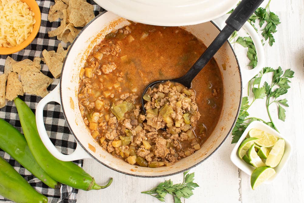 ground turkey green chili soup in a white dutch oven