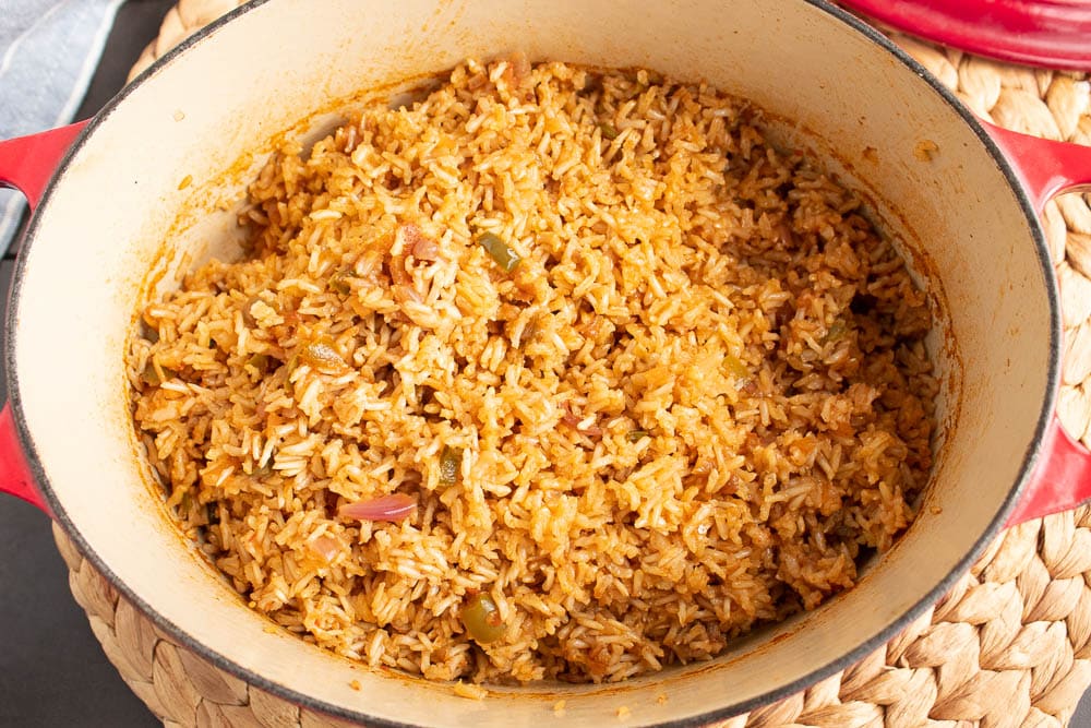 Cooled Easy Mexican Baked Rice right out of the oven in a red dutch oven fluffed up.