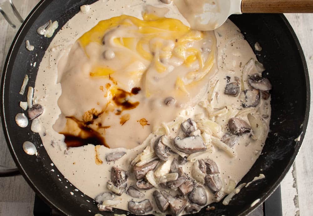 mushrooms, onions, garlic in a non stick skillet sauteing in butter with broth and cream cheese with canned soups and soy sauce and pepper added.