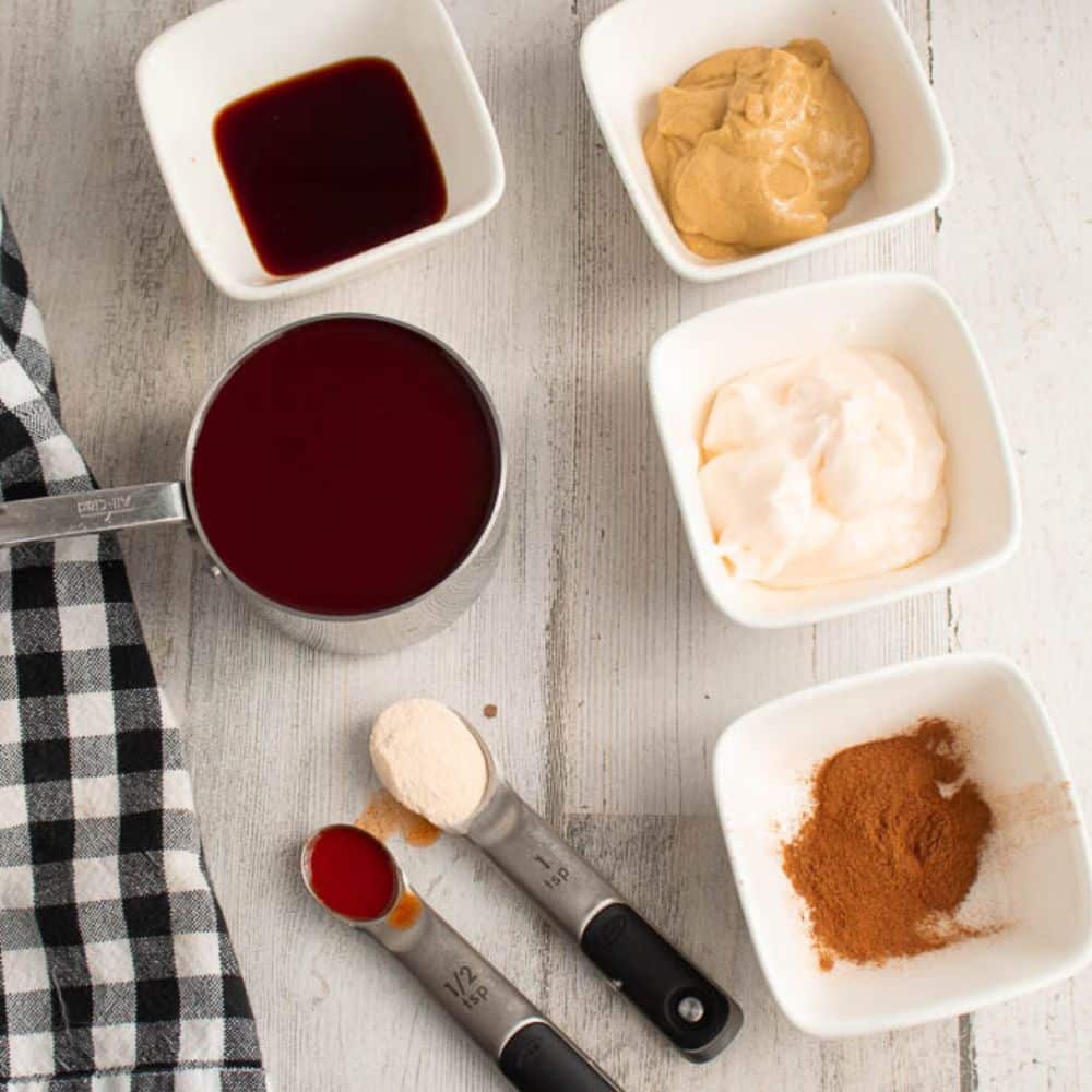 Semi-homemade BBQ sauce ingredients. on a gray table with a black and white checkered towel.